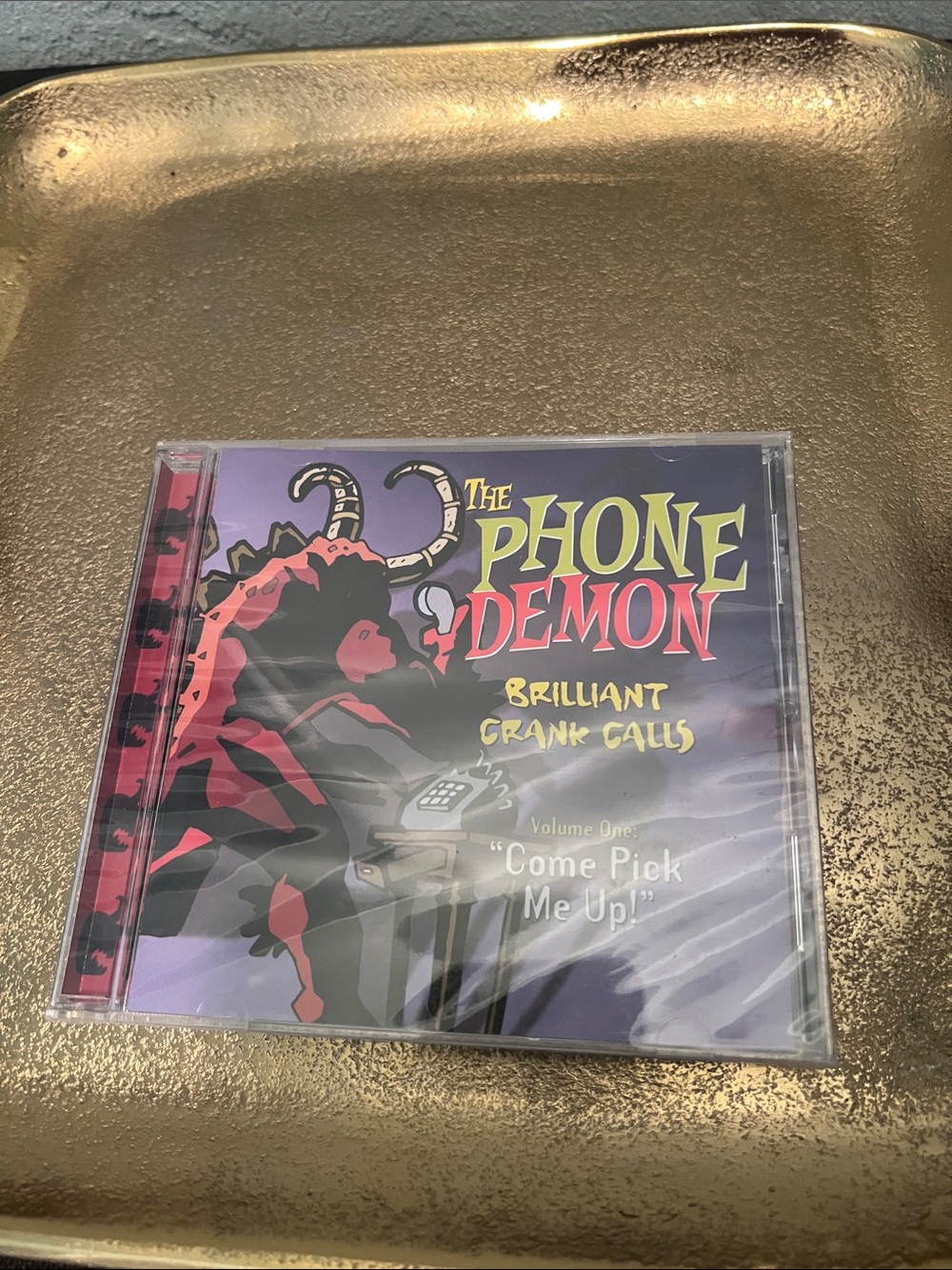 #2148**The Phone Demon Brilliant Crank Calls CD - Purple/Red